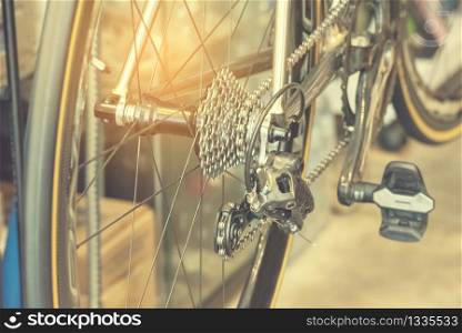 Vintage Bicycle part of bike cycle wheel interior Design with people lifestyle hobby in a modern city. Bicycle with sunlight background and loft decorating style focus on bike wheel