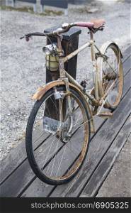 Vintage bicycle stands at the wooden pole