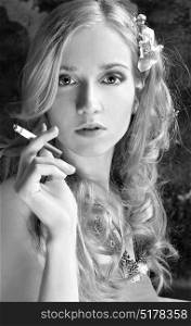 Vintage black and white portrait of a beautiful blonde model smoking