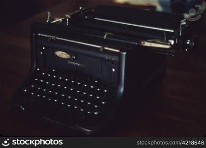 Vintage black Underwood typewriter on a dark wooden desk