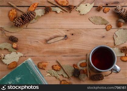 vintage book and drink in retro mug on wooden background. top view with space for text