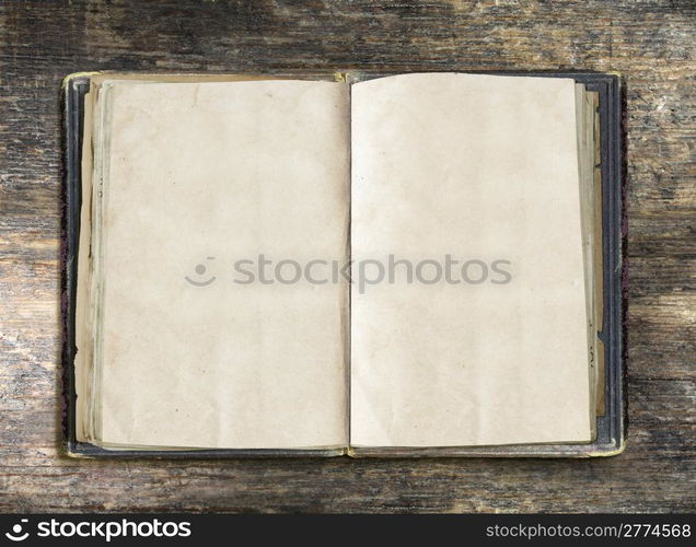 Vintage book, open, on old wooden table, with clipping path