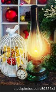 vintage burning lantern with christmas decorations, low key