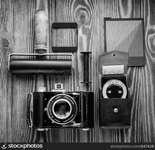 vintage camera,exposure meter and another trappings of film photography. photographer's desk. vintage camera,exposure meter and another trappings of film photography. photographer's desk.