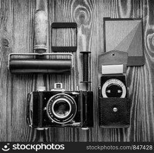vintage camera,exposure meter and another trappings of film photography. photographer's desk. vintage camera,exposure meter and another trappings of film photography. photographer's desk.