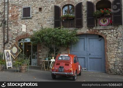 Vintage car on street against building, Radda in Chianti, Tuscany, Italy