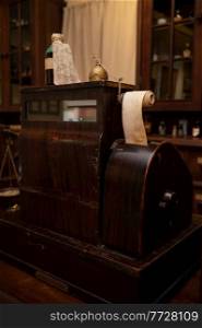 Vintage cash register in old pharmacy. Wooden antique furniture for medical drug storage. Vintage Cash Register