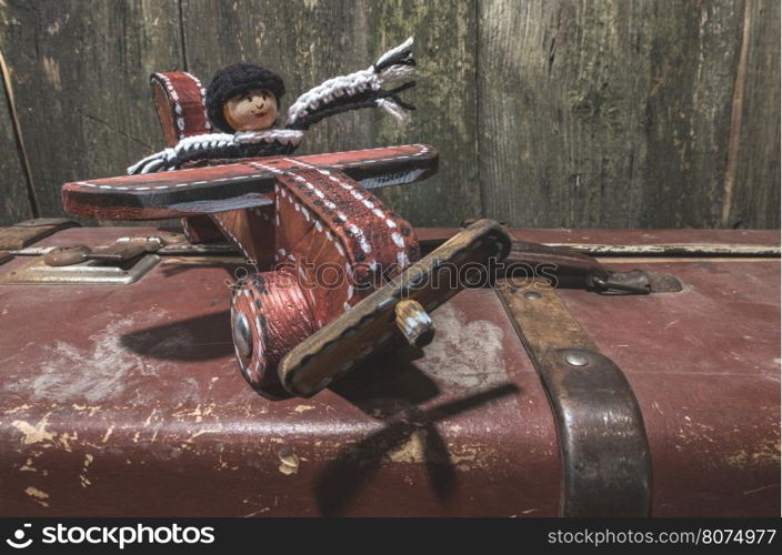 Vintage children's wooden toy airplane and manikin.