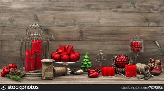 Vintage christmas decoration with red candles, stars and baubles. Retro style toned picture