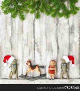 Vintage Christmas toys decoration on rustic wooden background. Christmas holidays banner with tree branches