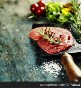 vintage cleaver and Beef Carpaccio on dark background