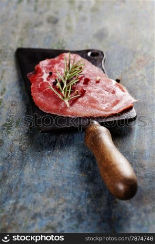 vintage cleaver and Beef Carpaccio on dark background