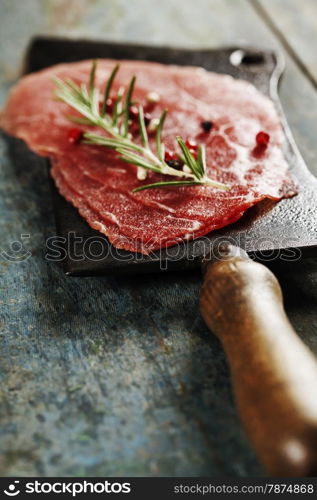 vintage cleaver and Beef Carpaccio on dark background