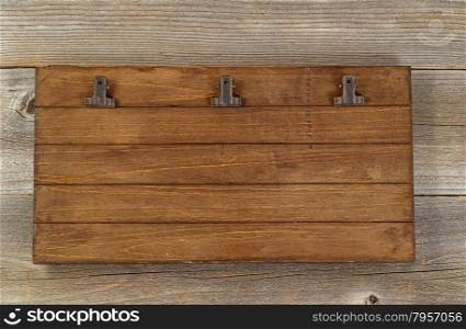 Vintage clipboard on rustic wooden desktop.
