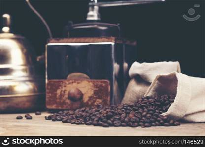 Vintage coffee grinder and beans on wooden background
