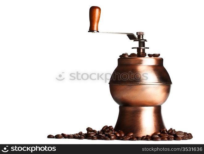 vintage coffee grinder standing on beans, white background