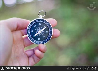 Vintage compass in man&rsquo;s hand, adventure and discovery concept