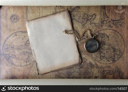 Vintage compass lying on old map