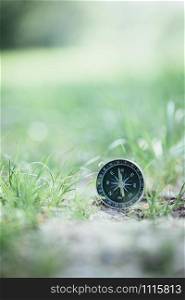 Vintage compass lying on the floor. Adventure and discovery concept.