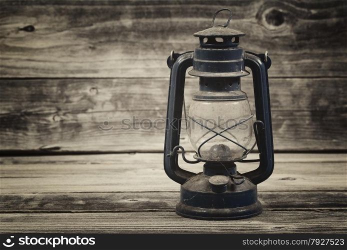 Vintage concept of a old lantern on rustic wood
