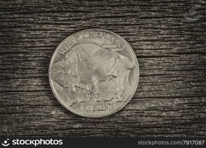 Vintage concept of Buffalo Nickel, reverse side, on rustic wood