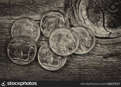 Vintage concept of old nickel coins on rustic wood