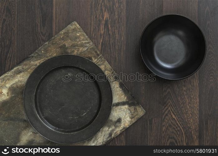 Vintage crockery bowls on rustic wooden background