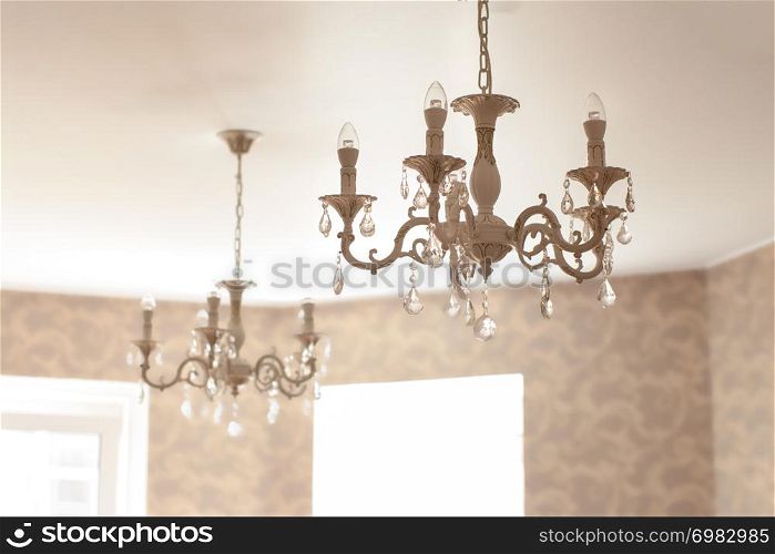 Vintage crystal glass chandelier with led lamps in living room.. Vintage crystal glass chandelier with led lamps in living room