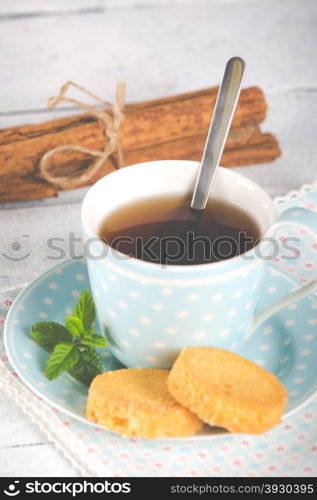 Vintage cup of tea flavored with cinnamon