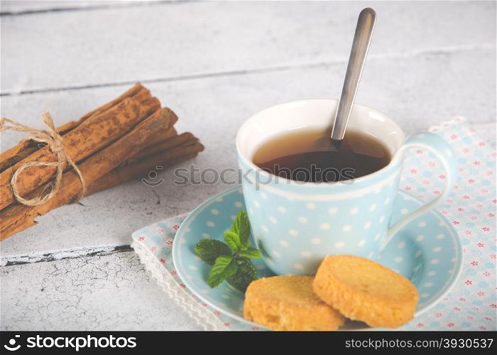 Vintage cup of tea flavored with cinnamon