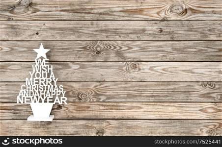 Vintage decoration Christmas tree on rustic wooden background. Merry Christmas! Happy New Year!