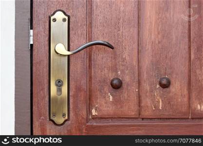 vintage door handle with keyhole on old wooden door