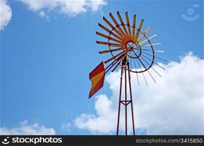 Vintage farm windmill against blue sky