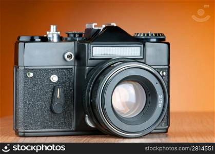 Vintage film camera against gradient background