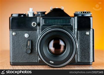 Vintage film camera against gradient background