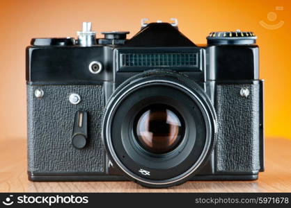 Vintage film camera against gradient background