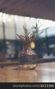 vintage flower in coffee cafe shop, vintage filter image