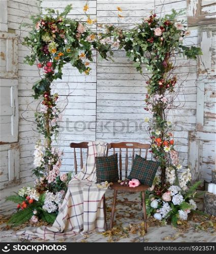 Vintage frame made from flowers, leaves with the grunge wooden background&#xA;