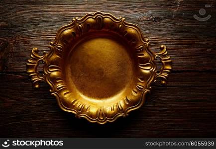 Vintage golden tray round on an aged brown wood background