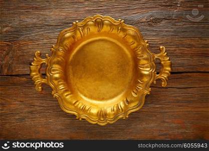 Vintage golden tray round on an aged brown wood background