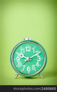 Vintage green clock on green background