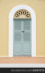 Vintage green window and door on yellow wall