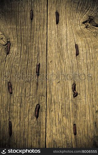 Vintage grunge wooden background door gate of the old castle detail with metal rusty nails.
