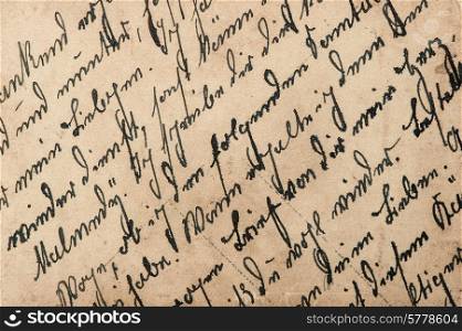 vintage handwriting with a text in undefined language. grungy textured paper background