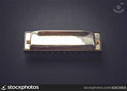 Vintage harmonica isolated on a black background. Vintage harmonica isolated on black