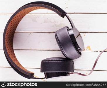 Vintage headset over white wooden background, horizontal image