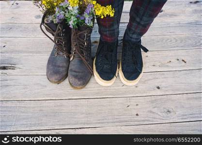 Vintage image with old boots filled with flowers