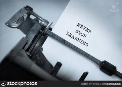 Vintage inscription made by old typewriter, Never stop learning