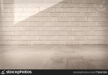 Vintage interior of white brick wall and old wooden floor. Toned image. Empty vintage room