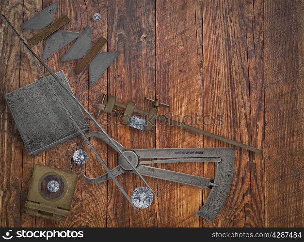 vintage jeweler tools and diamonds over wooden bench, space for text